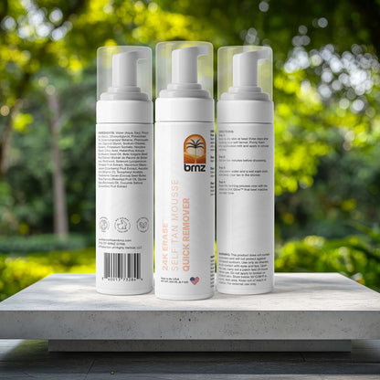 24K Erase self-tan remover bottles displayed on a sleek pedestal surrounded by a lush green background.