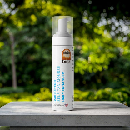 24K Extend self-tanner mousse bottle surrounded by lush greenery for glowing skin and hydration.