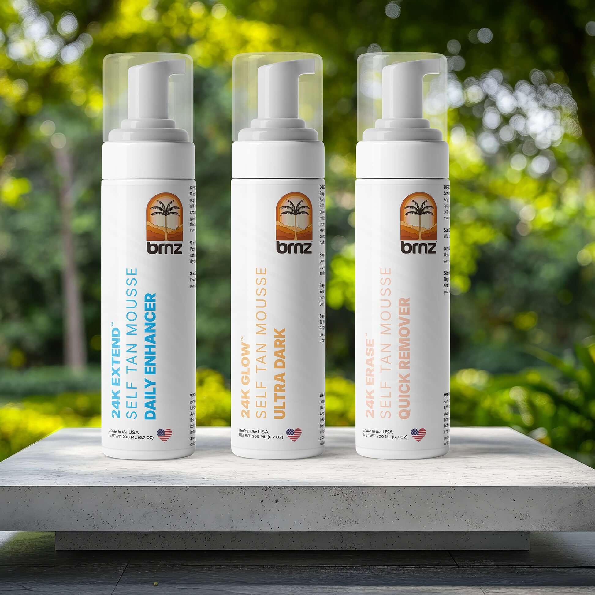 Three BRNZ self-tan products: 24K Extend daily enhancer, 24K Glow Ultra Dark, and 24K Erase quick remover on display.